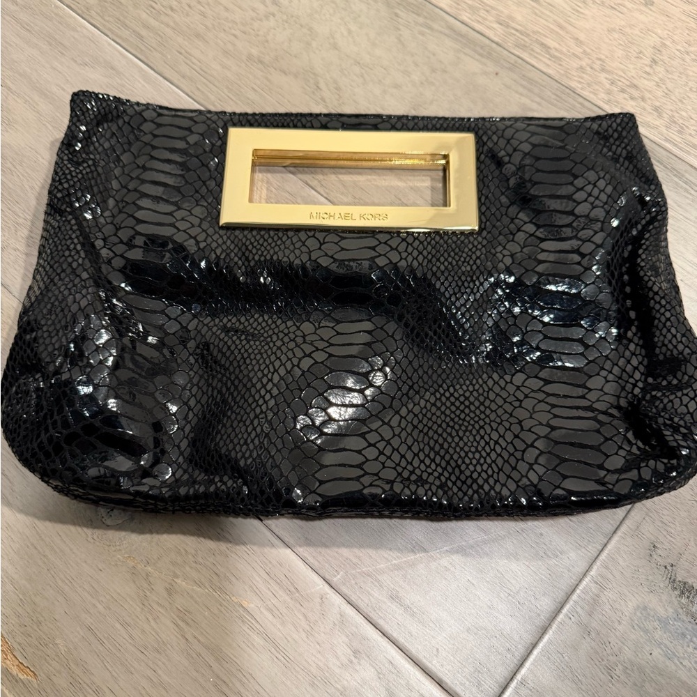 Michael Kors black snakeskin clutch w/ gold trim. Minor scratches on hardware.
